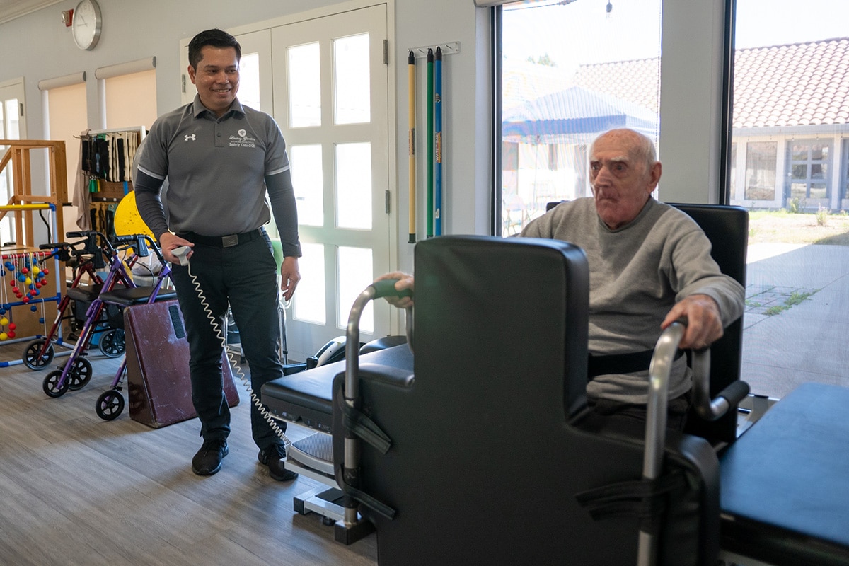 Therapist helping senior with rehabilitation